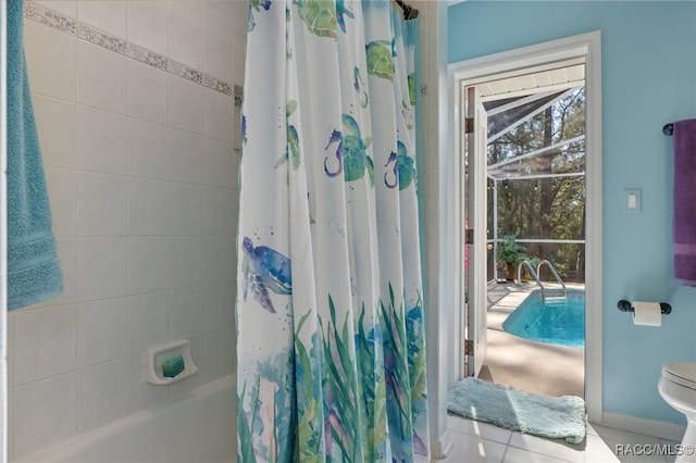 full bath featuring shower / tub combo, toilet, and tile patterned floors