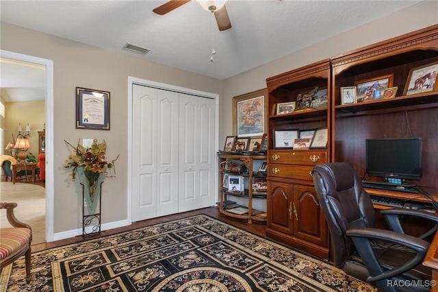 office featuring visible vents, ceiling fan, baseboards, and wood finished floors