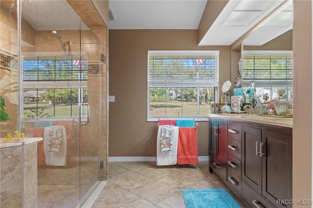 bathroom with a stall shower, visible vents, vanity, and baseboards