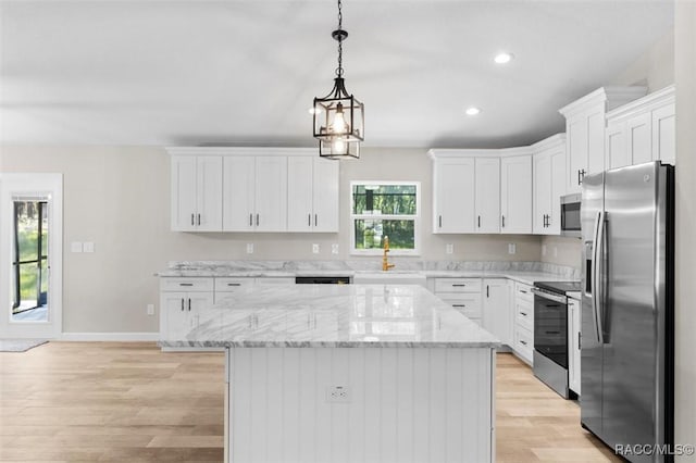 5379 N Nakoma Dr, Beverly Hills, FL 34465 - kitchen featuring appliances with stainless steel finishes, light wood finished floors, white cabinetry, decorative light fixtures, and recessed lighting