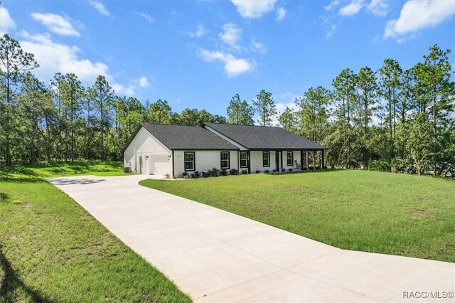 5379 N Nakoma Dr, Beverly Hills, FL 34465 - ranch-style home with concrete driveway, a front lawn, and an attached garage