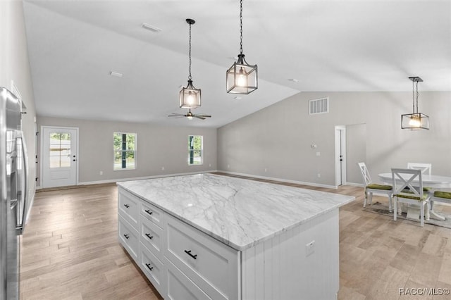 5379 N Nakoma Dr, Beverly Hills, FL 34465 - kitchen featuring vaulted ceiling, open floor plan, a ceiling fan, white cabinetry, and hanging light fixtures
