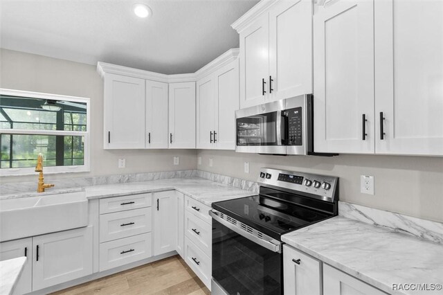 5379 N Nakoma Dr, Beverly Hills, FL 34465 - kitchen featuring stainless steel appliances, white cabinets, recessed lighting, light stone countertops, and light wood-style flooring