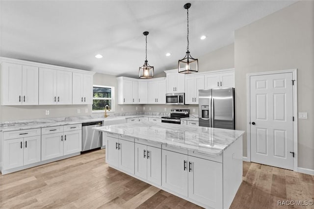 5379 N Nakoma Dr, Beverly Hills, FL 34465 - kitchen featuring appliances with stainless steel finishes, a center island, white cabinets, light wood-type flooring, and recessed lighting