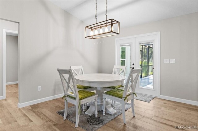 5379 N Nakoma Dr, Beverly Hills, FL 34465 - dining space with french doors, wood finished floors, and a chandelier
