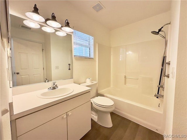 full bathroom featuring visible vents, wood finished floors, toilet, and vanity