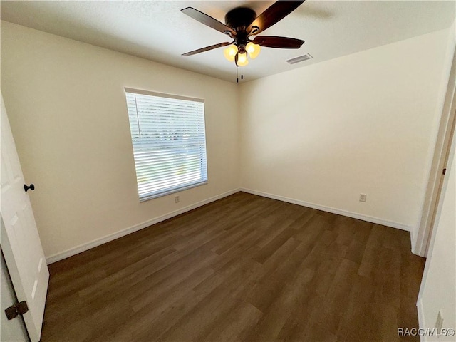 unfurnished bedroom with baseboards, visible vents, and dark wood finished floors