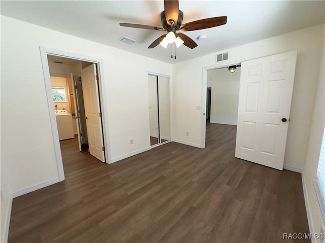 unfurnished bedroom featuring visible vents, dark wood finished floors, baseboards, and a closet