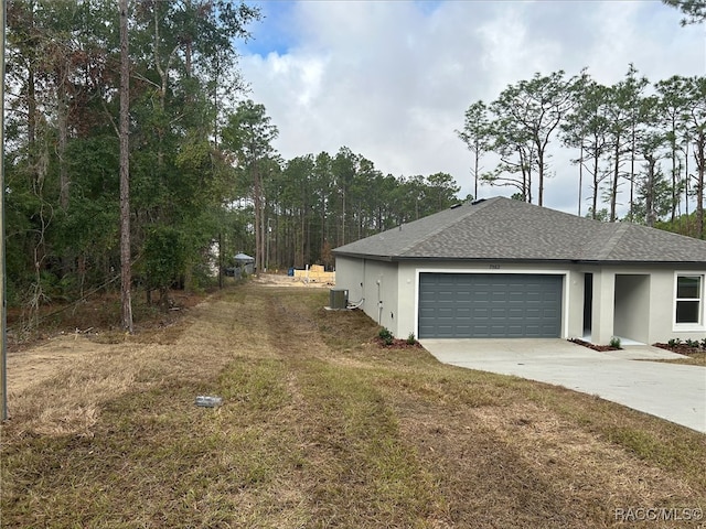 view of home's exterior featuring a garage and central AC unit