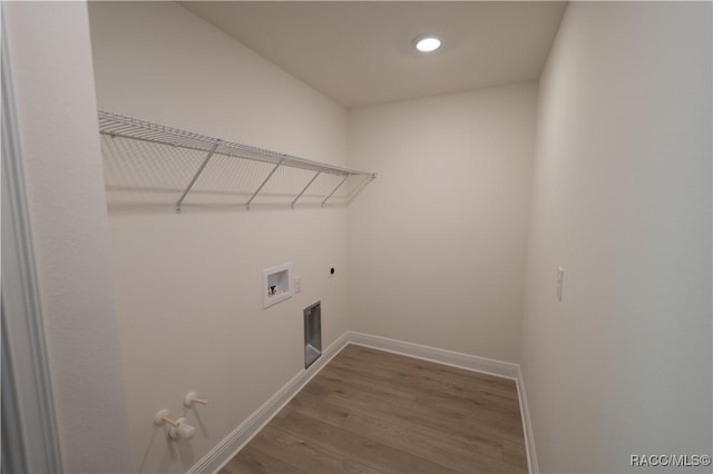 laundry room featuring electric dryer hookup, gas dryer hookup, hookup for a washing machine, and hardwood / wood-style flooring