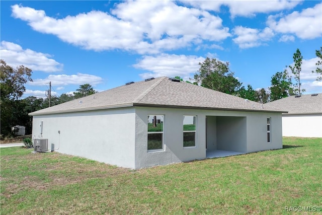 view of property exterior with a yard and central air condition unit