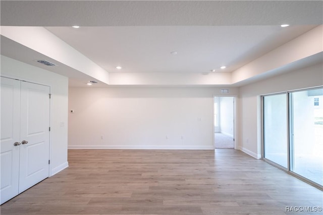 empty room with light hardwood / wood-style flooring