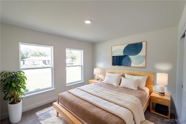 bedroom featuring carpet flooring and multiple windows