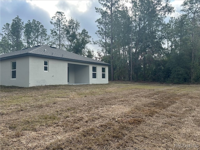 rear view of property with a yard