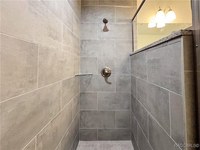 bathroom with a tile shower