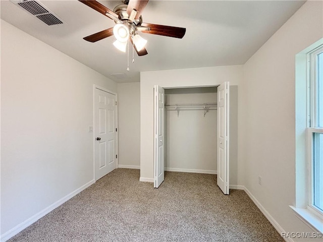 unfurnished bedroom with ceiling fan, light colored carpet, visible vents, baseboards, and a closet