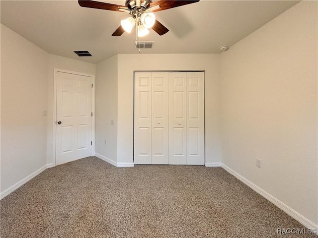 unfurnished bedroom with carpet floors, visible vents, and baseboards