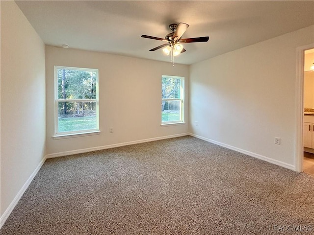 unfurnished room with carpet floors, ceiling fan, and baseboards