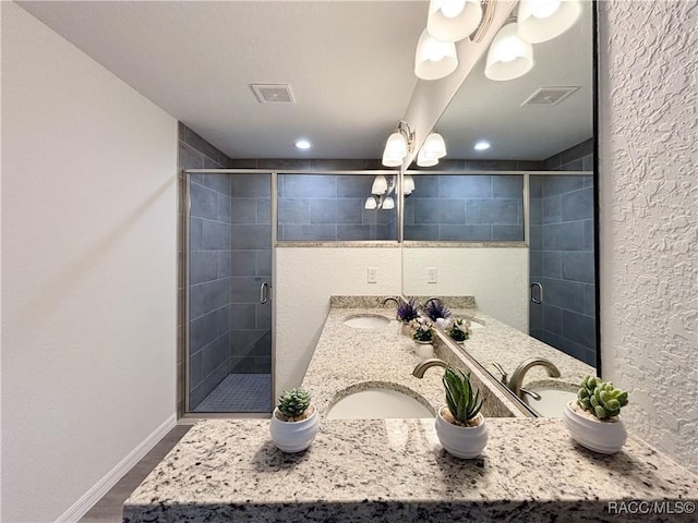 1370 SW Obee Ridge Rd, Dunnellon, FL 34430 - bathroom featuring double vanity, a stall shower, wood finished floors, and recessed lighting