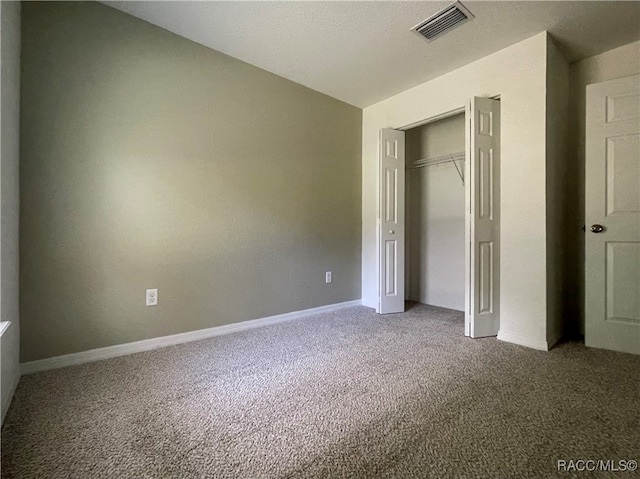 unfurnished bedroom featuring a closet and carpet floors