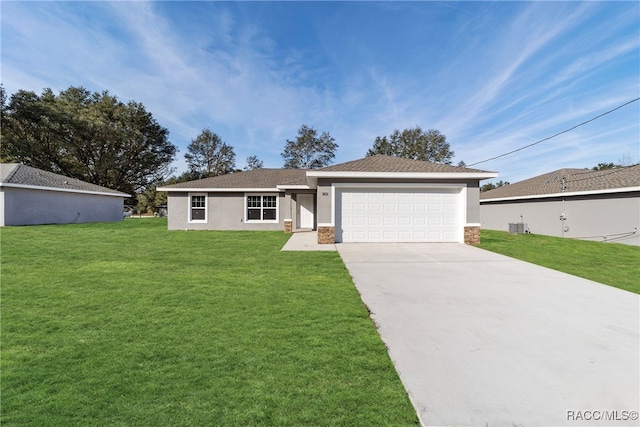 single story home with central AC, a front lawn, and a garage