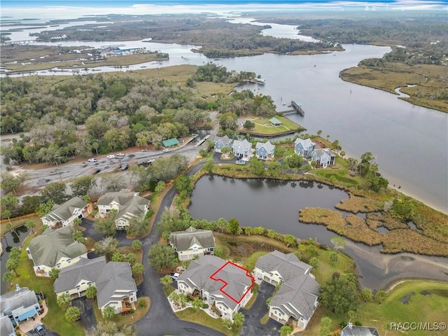 birds eye view of property with a water view and a residential view