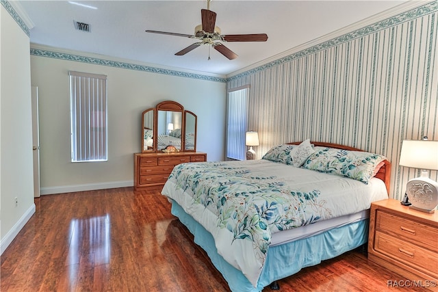 bedroom with dark hardwood / wood-style floors, ceiling fan, and crown molding