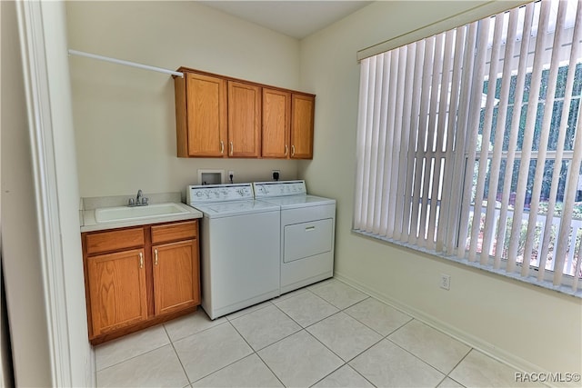 washroom with washer and dryer, light tile patterned flooring, cabinets, and sink