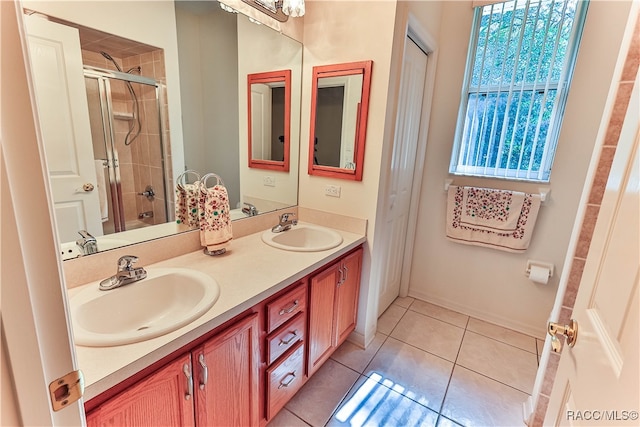 bathroom with tile patterned flooring, vanity, and a wealth of natural light