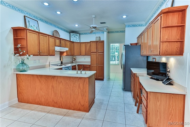 kitchen featuring kitchen peninsula, white range, crown molding, and sink