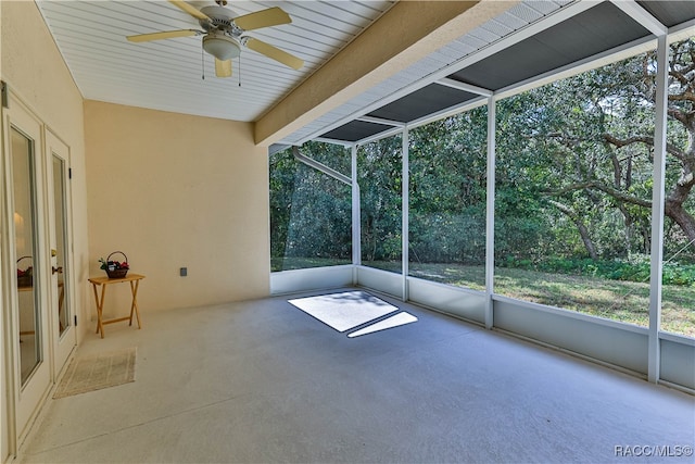 unfurnished sunroom featuring ceiling fan