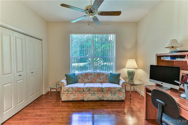 office area with ceiling fan and dark wood-type flooring