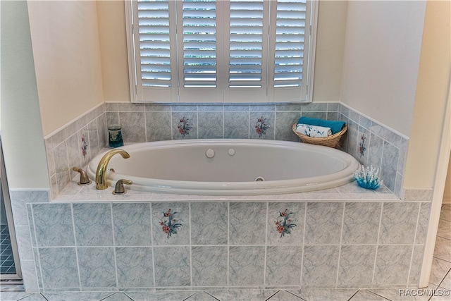 bathroom featuring tile patterned floors and tiled tub