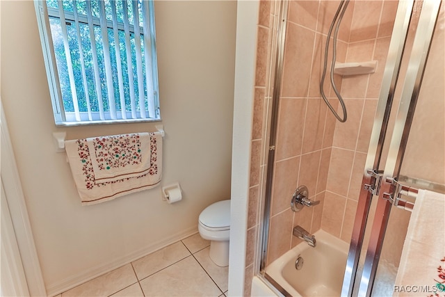 bathroom with shower / bath combination with glass door, tile patterned floors, and toilet