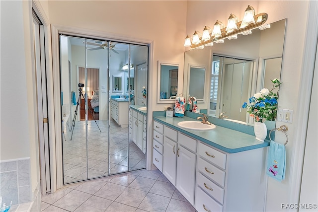 bathroom with ceiling fan, tile patterned flooring, and vanity