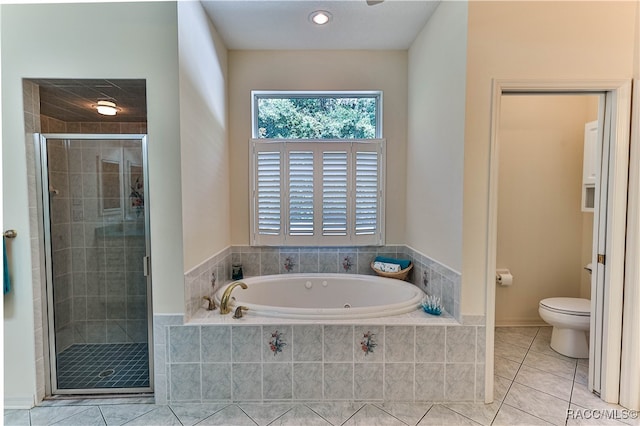 bathroom featuring tile patterned flooring, shower with separate bathtub, and toilet