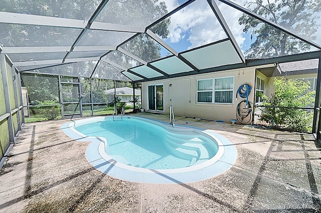 view of pool with a patio area and a lanai