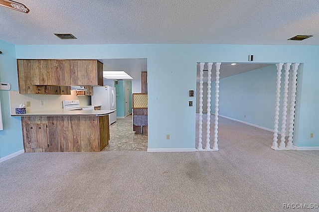 kitchen featuring kitchen peninsula, light carpet, white appliances, a textured ceiling, and range hood