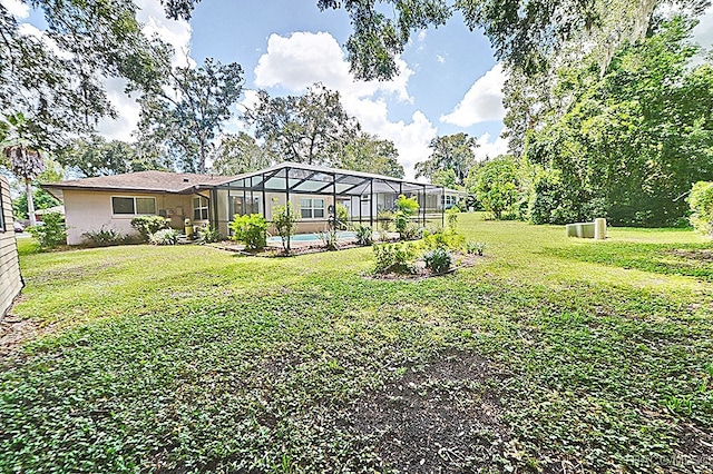 view of yard featuring a lanai and a pool