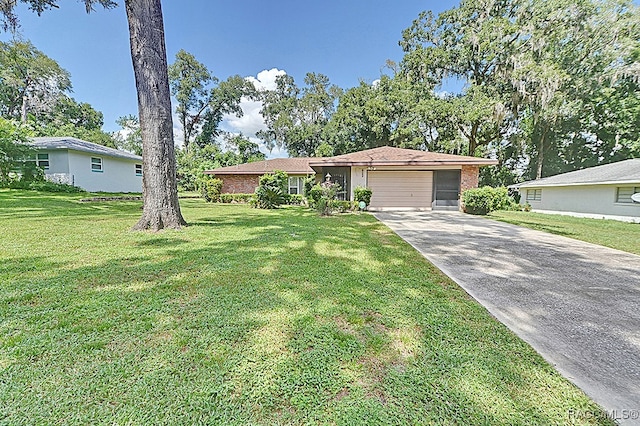 ranch-style home with a garage and a front lawn