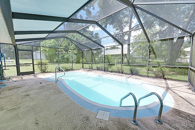 view of swimming pool with a lanai and a patio area