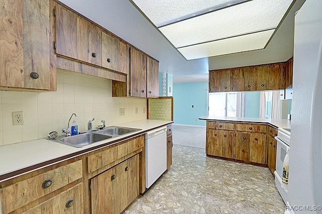 kitchen with backsplash, sink, and white appliances