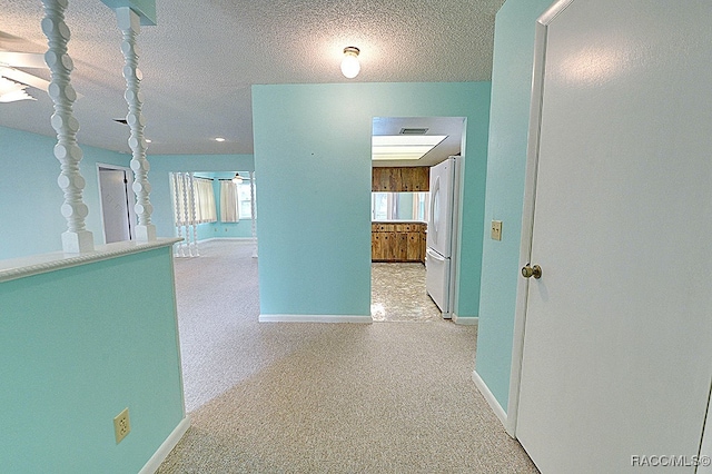 corridor featuring a textured ceiling