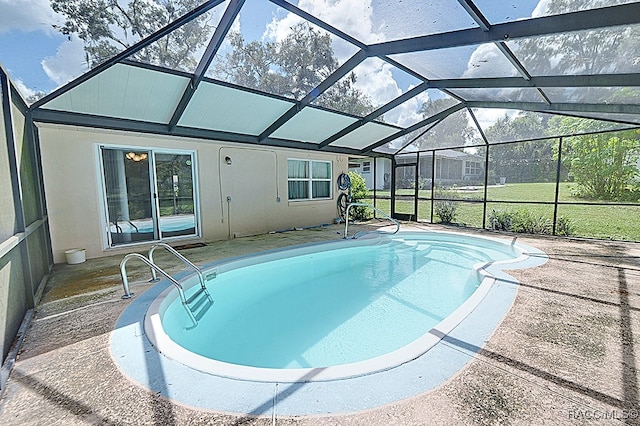 view of pool with a lanai and a patio area