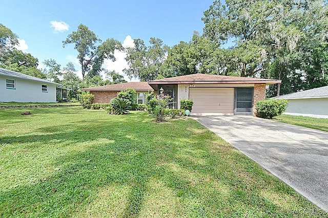 ranch-style house featuring a front yard and a garage