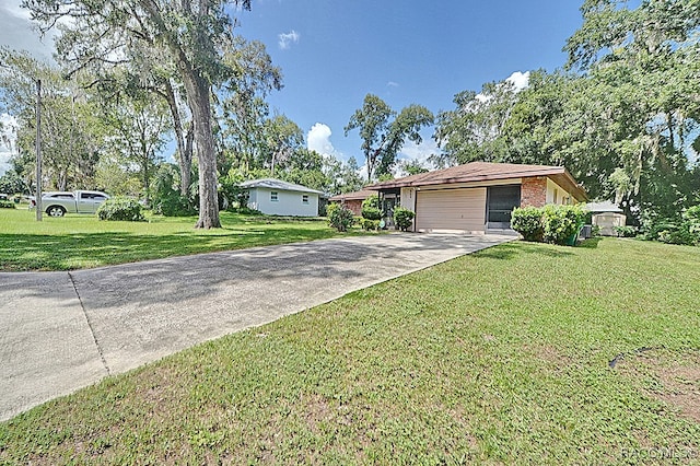 single story home with a garage and a front yard