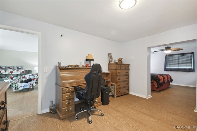 home office featuring hardwood / wood-style flooring and ceiling fan