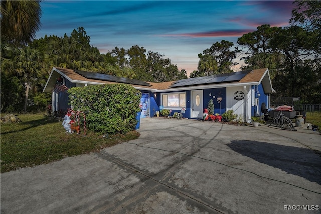 single story home featuring solar panels