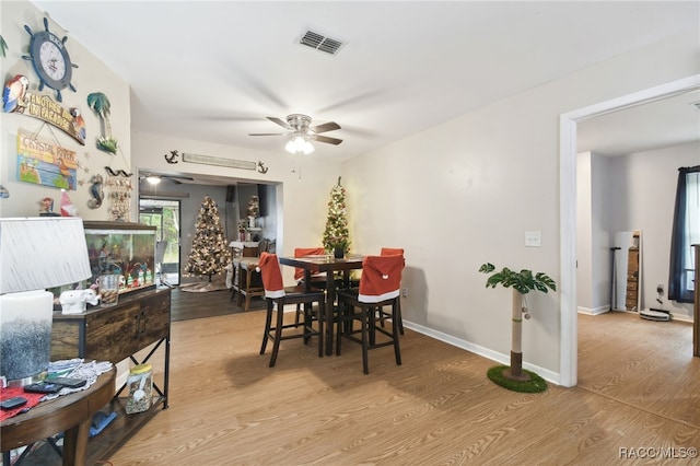 dining area with ceiling fan and light wood-type flooring