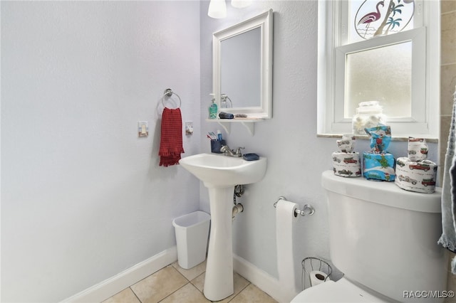 bathroom with tile patterned flooring and toilet